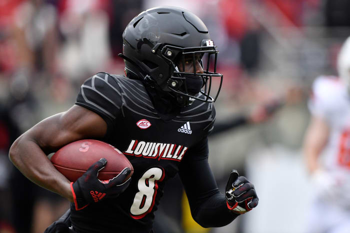 Louisville Cardinals wide receiver Tyler Harrell (8) runs the ball against the Syracuse Orange during the first quarter at Cardinal Stadium. Louisville defeated Syracuse 41-3.